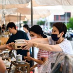 從攤販手中接過最適合午後享用的輕食，攤販同時將心意以雙手一同遞上，彼此的這份互動是盛夏美好的一景。