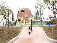 新業(yè)建設(shè)董事長卓勝隆童心大發(fā)，在碉堡地景溜滑梯。